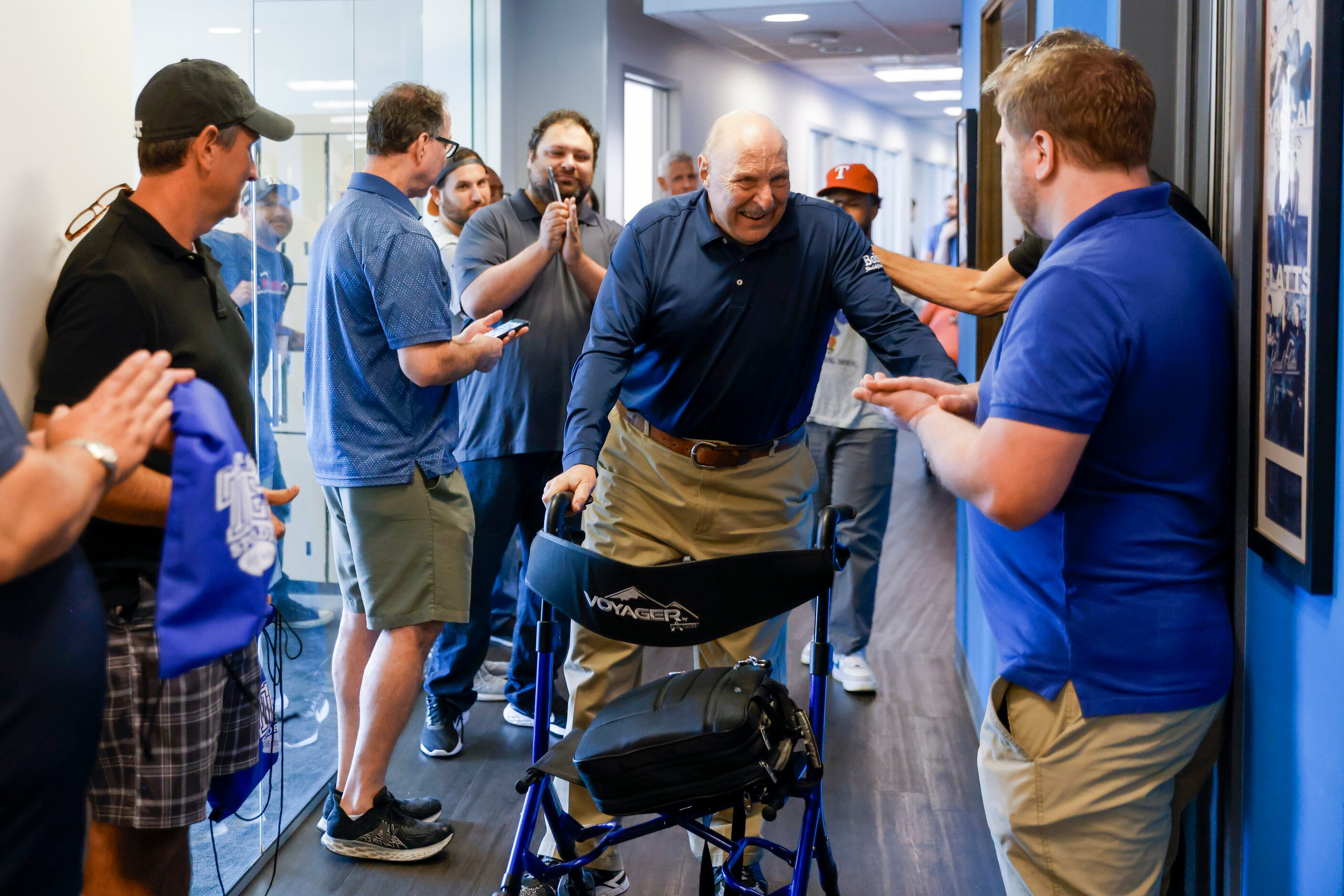 Local sports radio legend Norm Hitzges reacts as he walks through a honor walk after his...