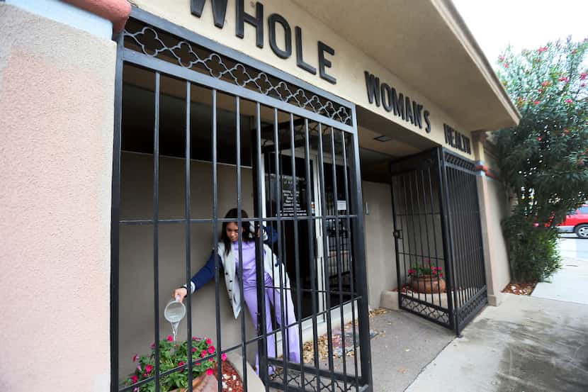  Lucy, a patient advocate, watered potted flowers at Whole Woman's Health in McAllen, which...