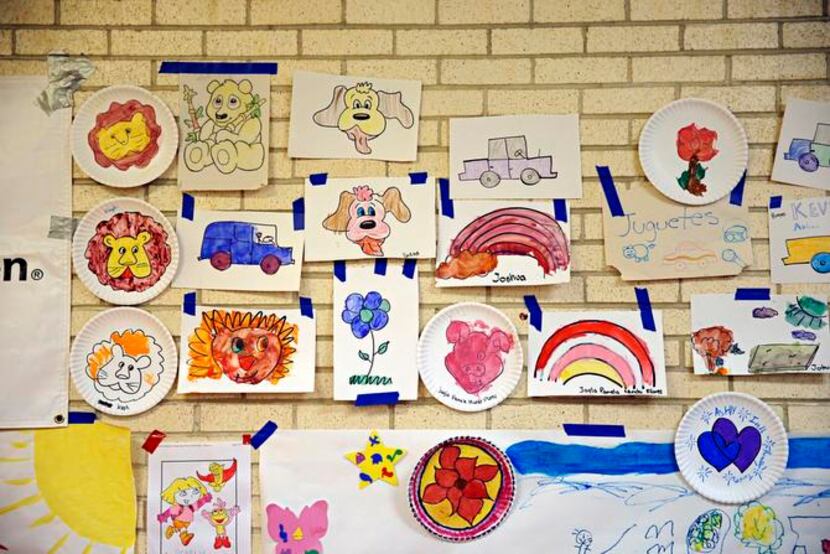 
Drawings made by migrant children hang on a wall at Sacred Heart Catholic Church Wednesday,...