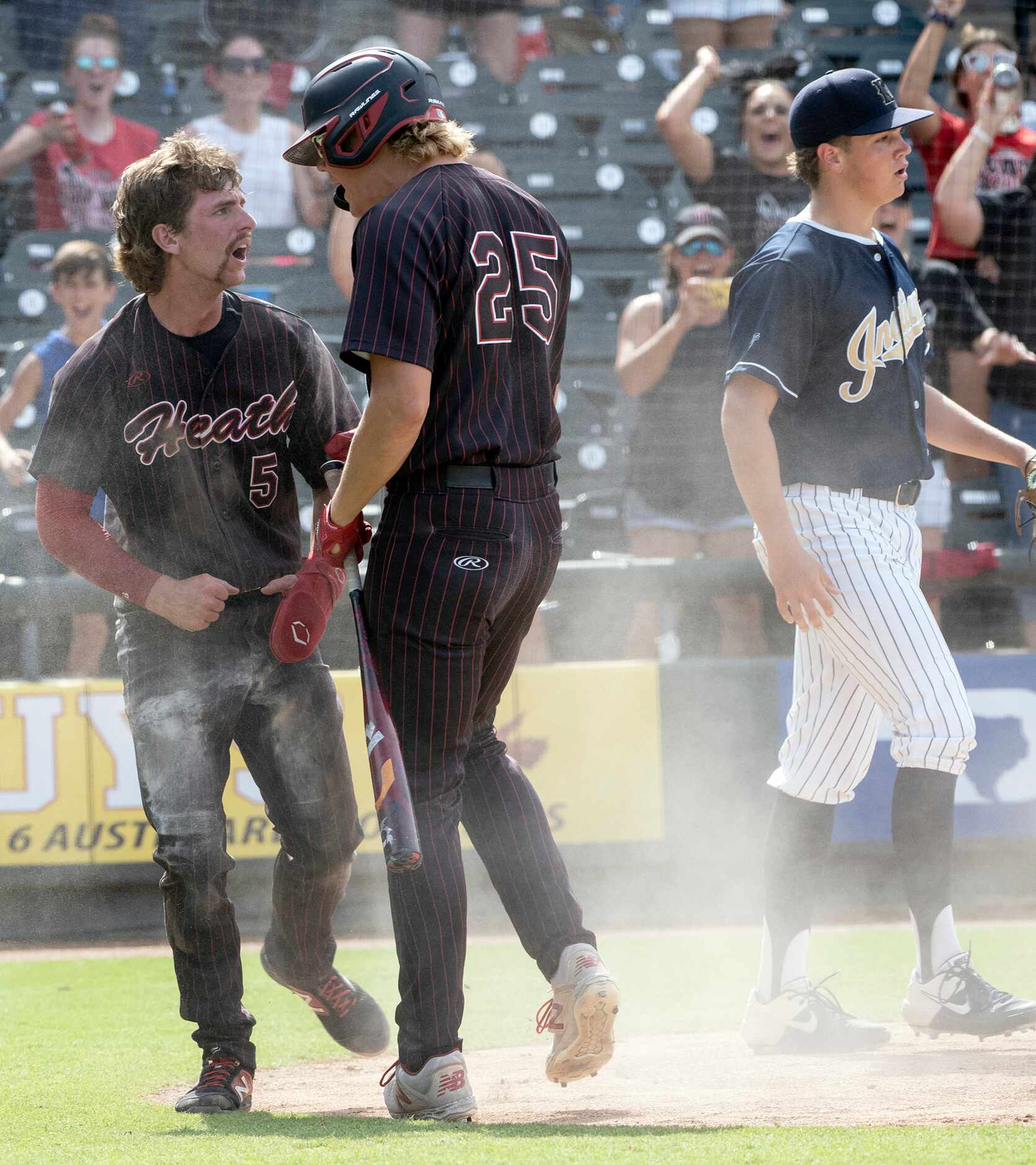 Rockwall-Heath Karson Krowka, (5), celebrates with teammate Kaston Mason, (25), after...