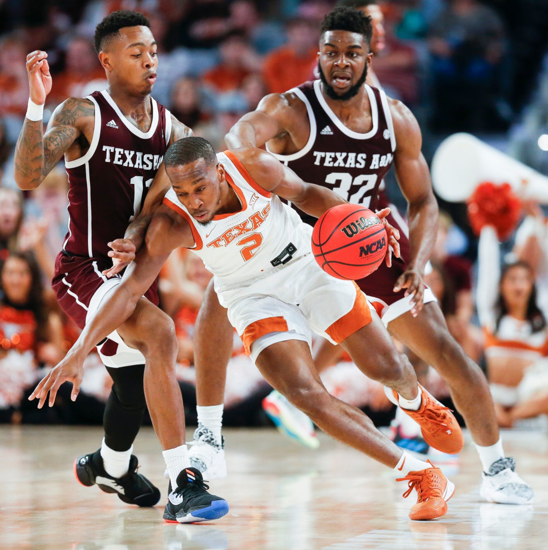 Texas Longhorns guard Matt Coleman III (2) drives past Texas A&M Aggies guard Wendell...