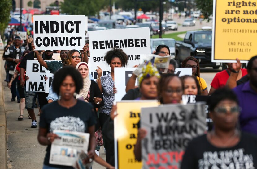 People march during a protest prior to the start of the Dallas Cowboys' game against the New...