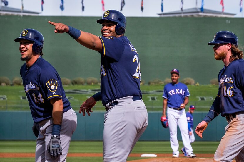 Milwaukee Brewers third baseman Hernan Perez (14), first baseman Jesus Aguilar (24) and left...