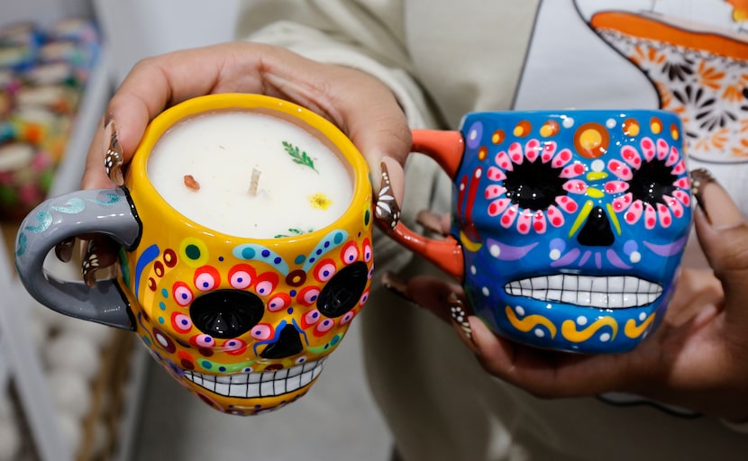 Grecia Alfaro shows candles for the Day of the Dead at her candle shop, “Luz Y Tierra,”...