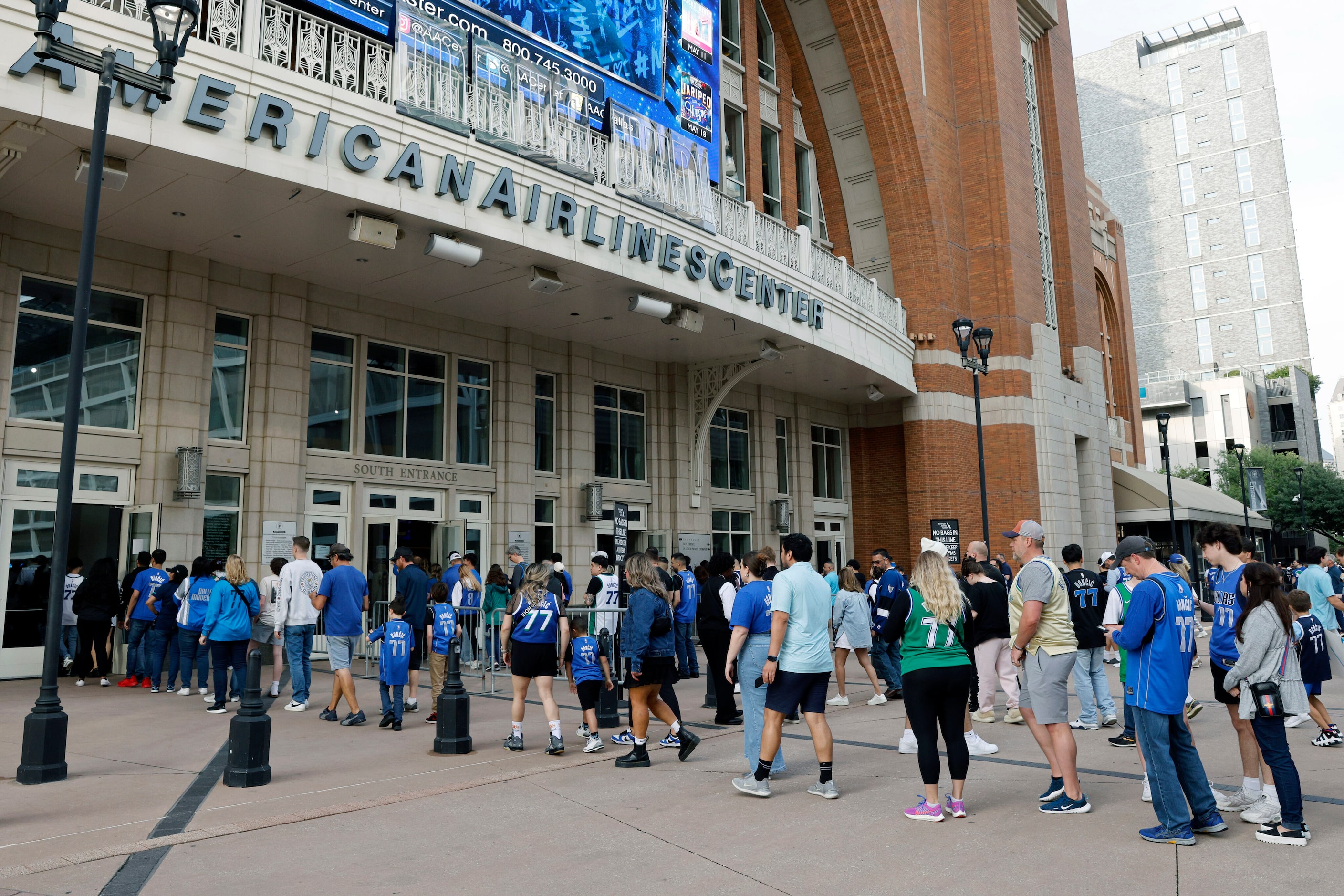 Fans make their way into the American Airlines Center before Game 3 of an NBA basketball...