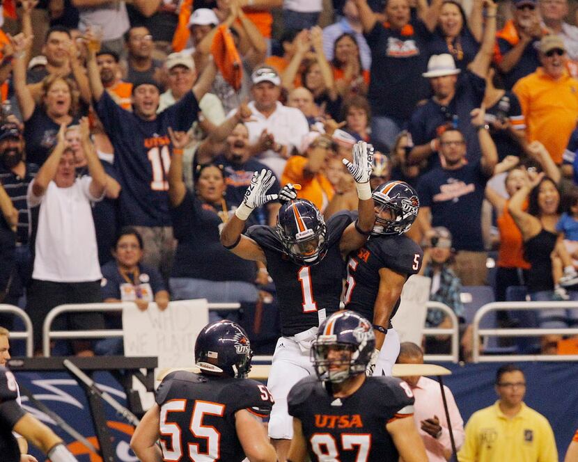 UTSA's Kam Jones, left, and Brandon Armstrong leap to celebrate a touchdown during the first...