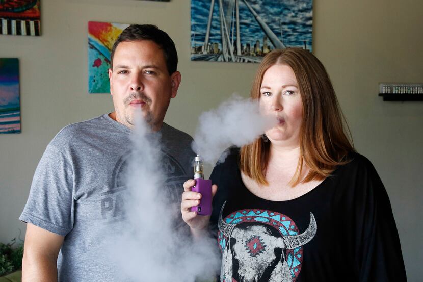 Chris and Erin Freeman, co-owners of Good Vapes in Dallas, demonstrate how a Vaping device...
