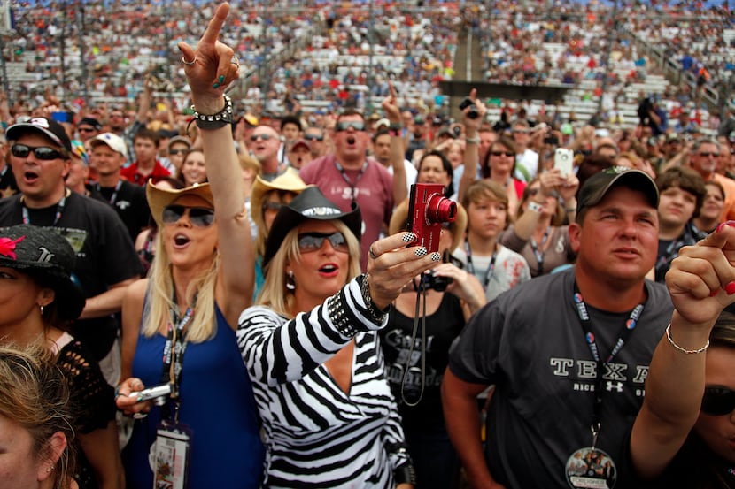 Foreigner fans cheer during a pre-race concert on the frontstretch at the NASCAR Sprint Cup...