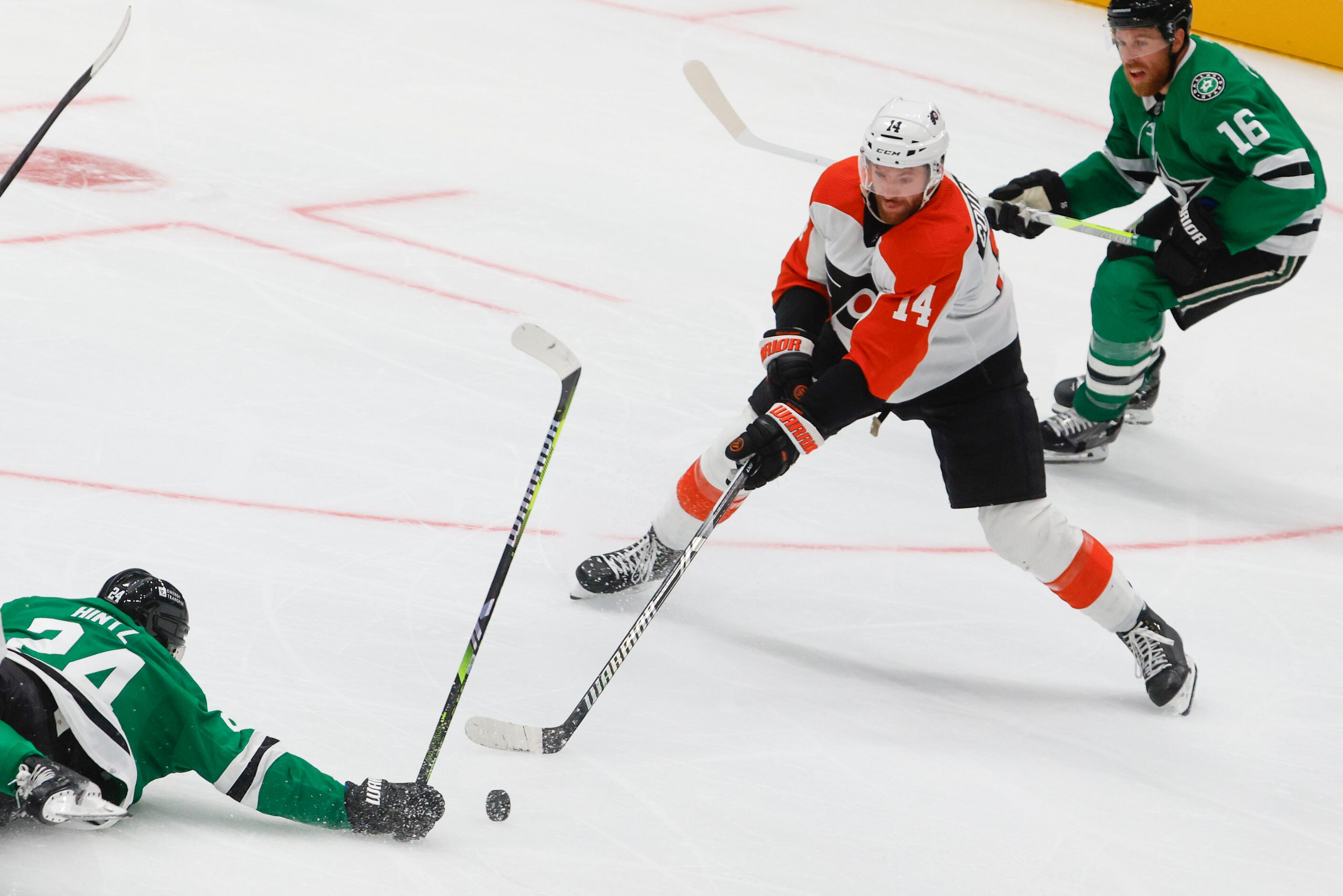 Dallas Stars center Roope Hintz (left) misses to handle the puck against Philadelphia Flyers...