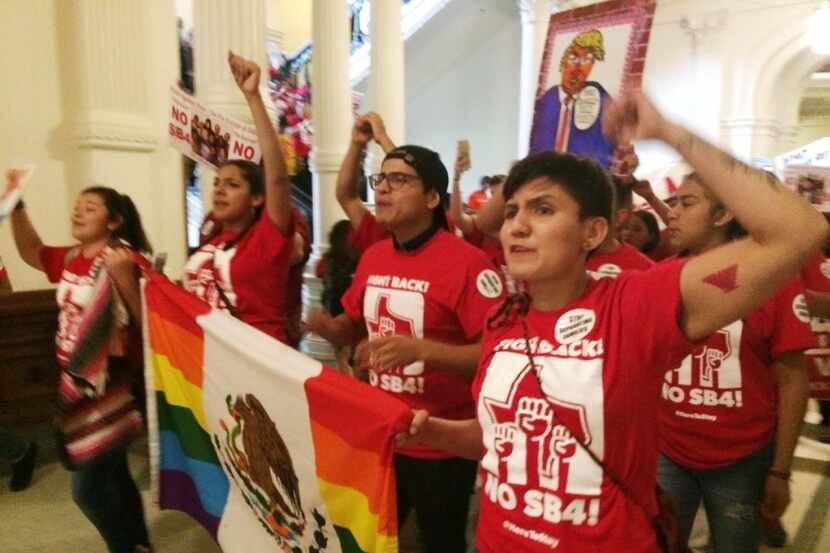 Demonstrators in the Texas Capitol protest the state's newly passed anti-sanctuary cities...