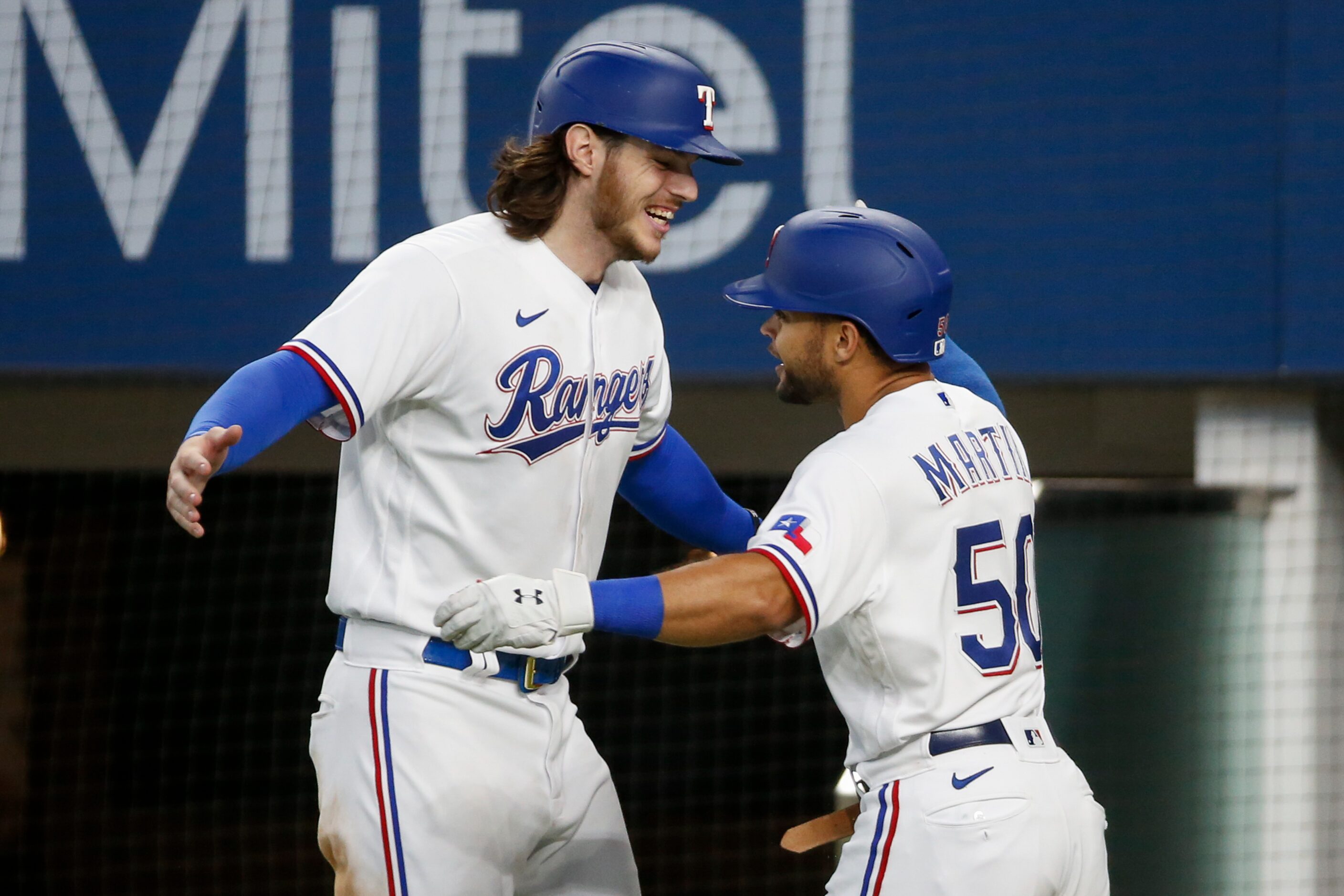 Texas Rangers catcher Jonah Heim (28) and Texas Rangers left fielder Jason Martin (50)...