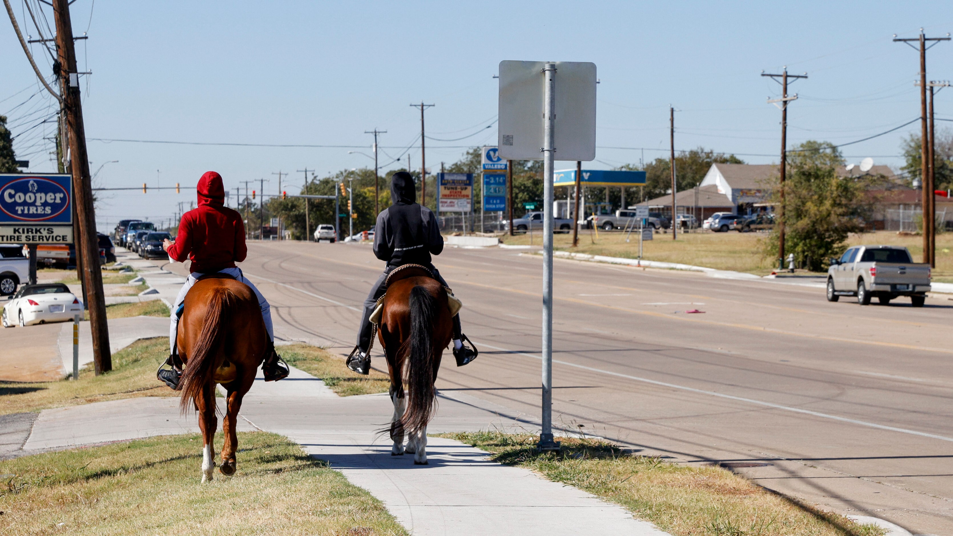 Markel Walker rides his horse Governor (left) alongside Bobby Dow and his horse Deuce on...