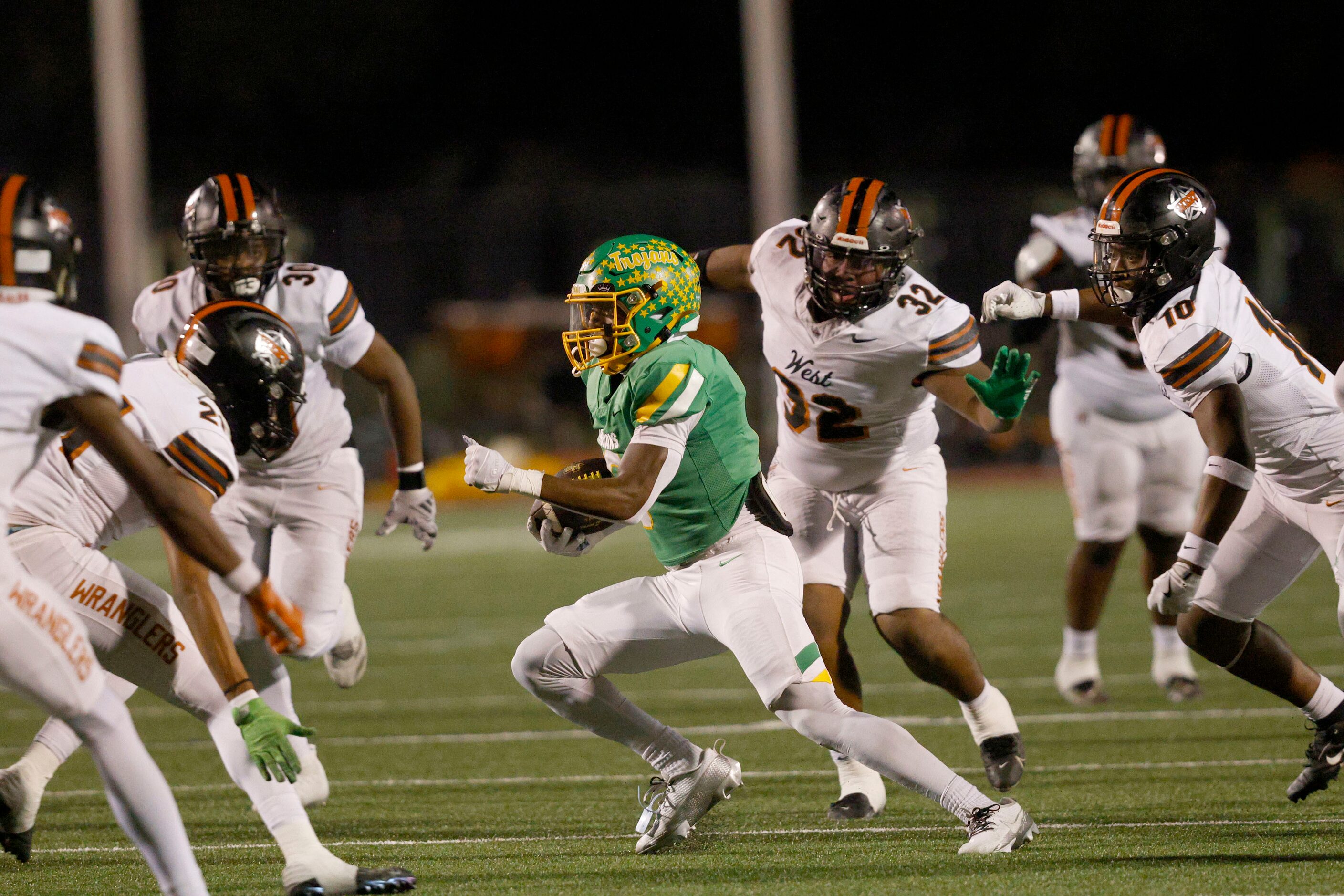 Newman Smith's Allijah Harrison (6), center, carries the ball in the first half of a high...