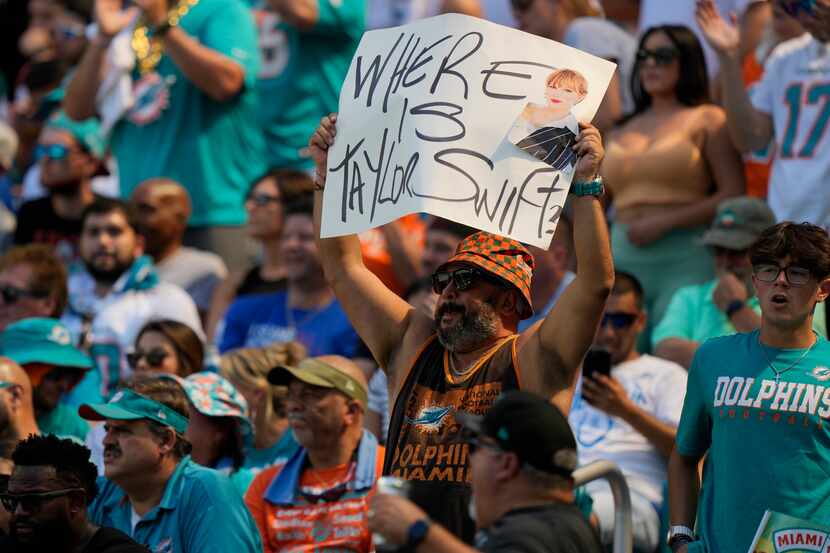 A Miami Dolphins fan displays a "Where is Taylor Swift" sign during the first half of an NFL...