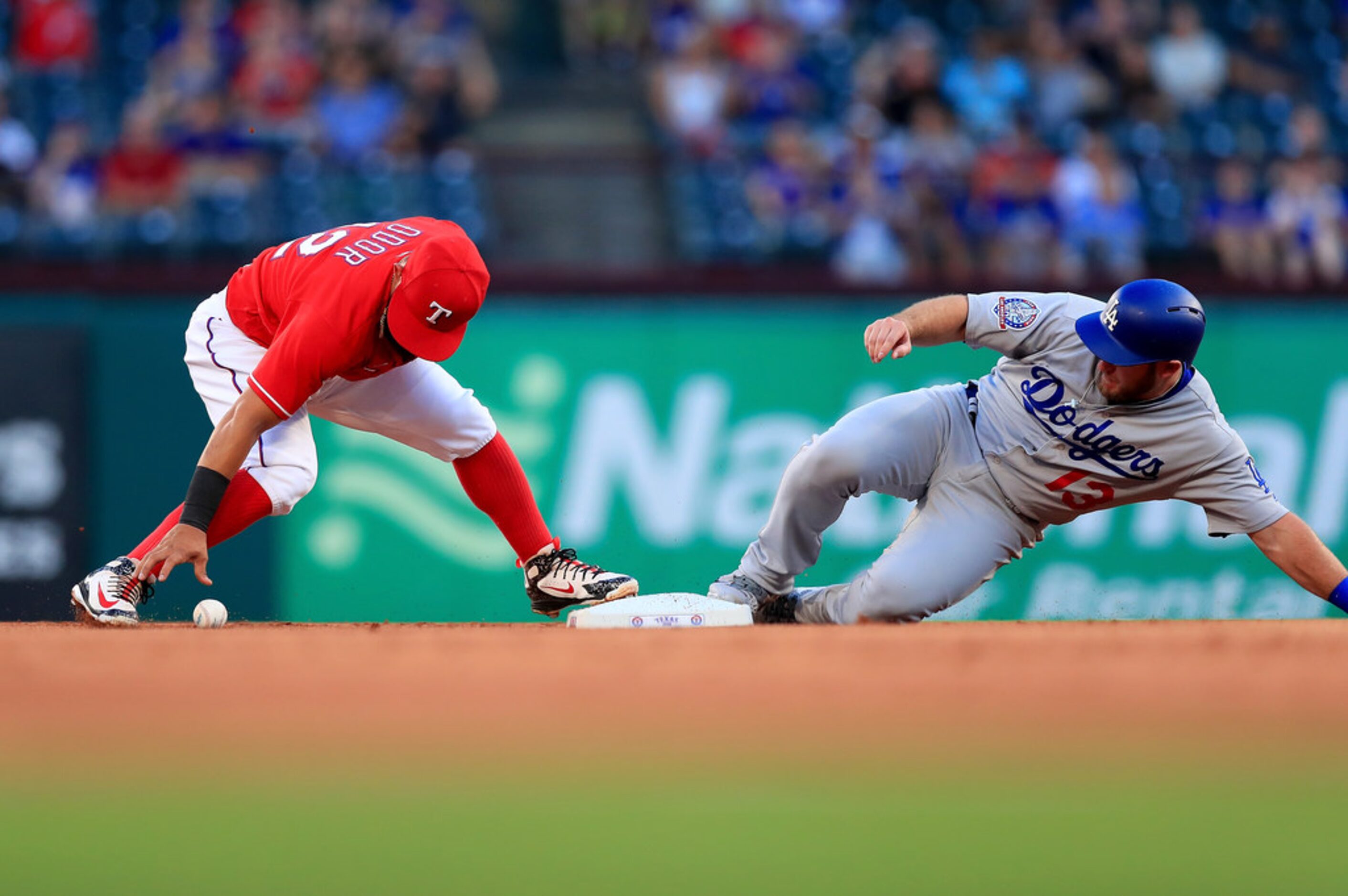 ARLINGTON, TX - AUGUST 28:  Rougned Odor #12 of the Texas Rangers commits an error fielding...