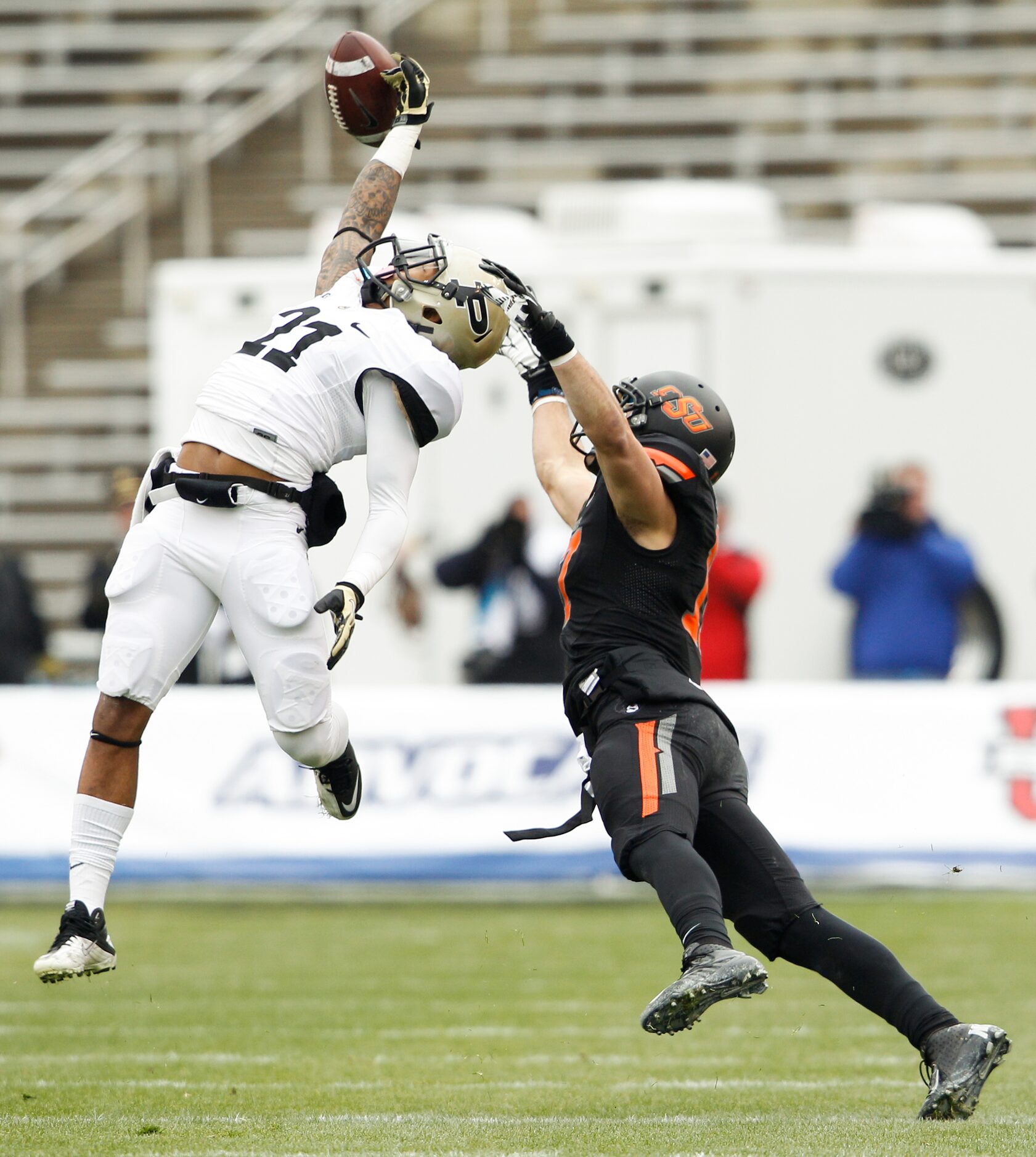 Purdue's Ricardo Allen (21) gets his fingertips on a pass intended for Oklahoma State's...