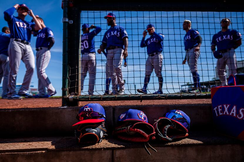 Texas Rangers players prepare to take the field  before a spring training baseball game...