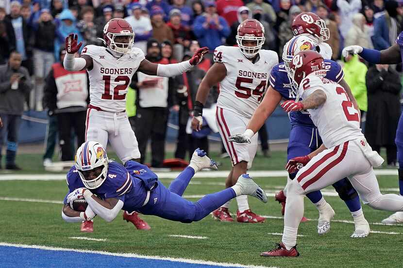 Kansas running back Devin Neal dives into the end zone to score a touchdown during the...