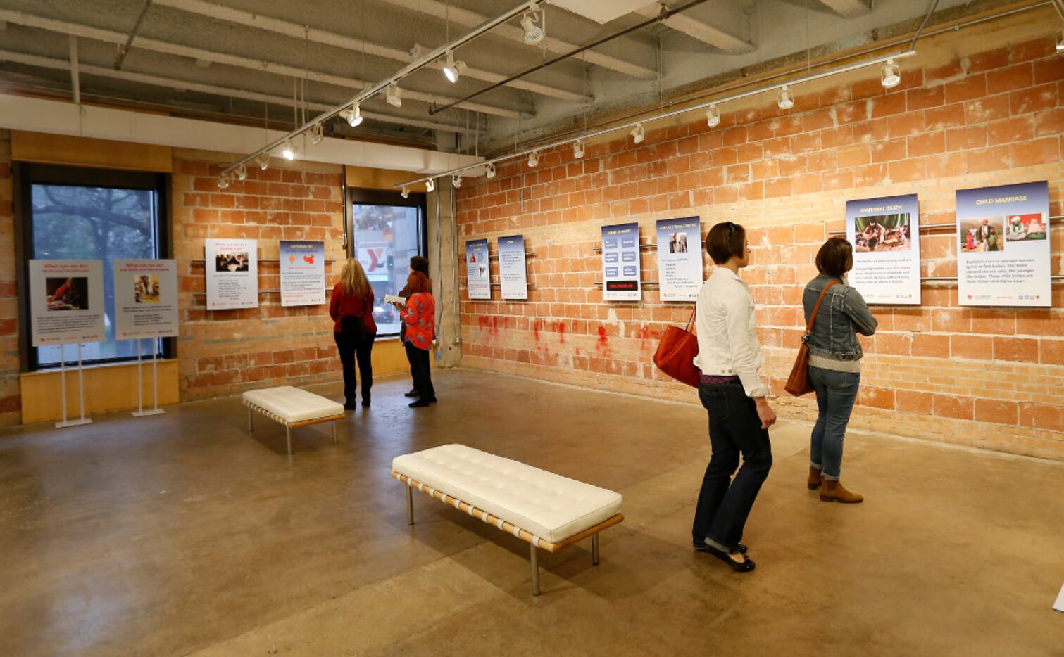 Visitors took in information at the exhibit on its opening day Friday. (Jae S. Lee/Staff...