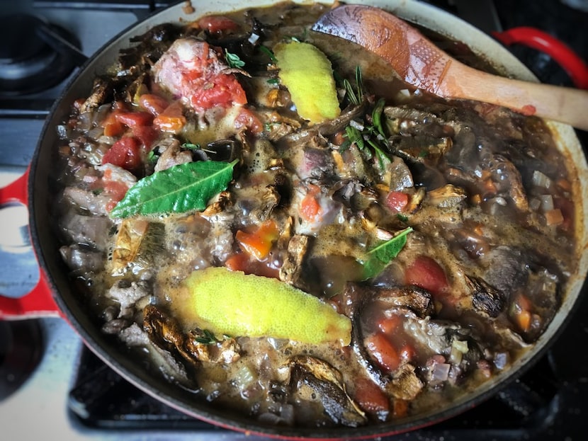 Lamb bolognese cooking. Bay leaves, rosemary and lemon heighten the flavors.