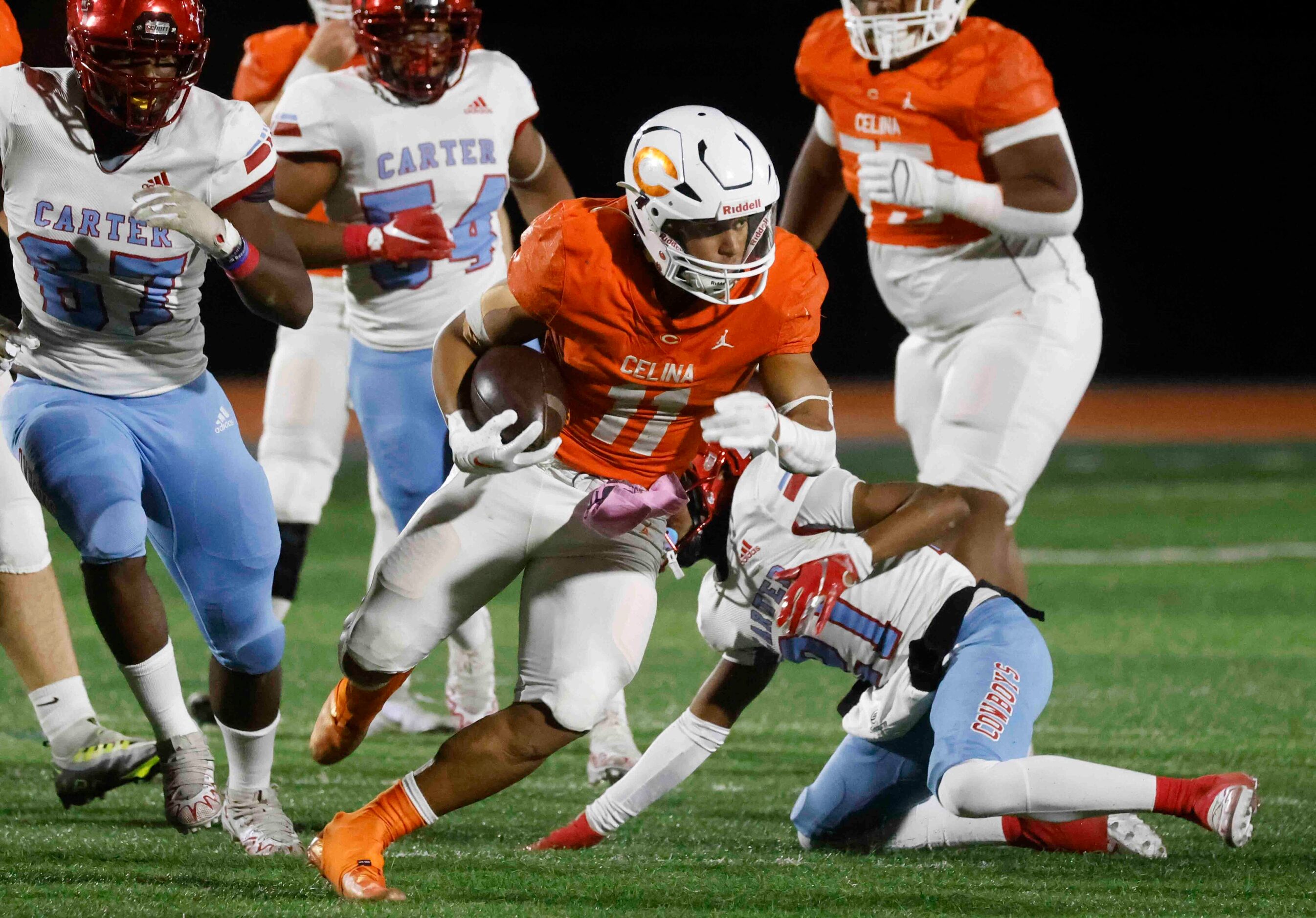 Celina High School’s Gabe Gayton (11) runs for a yardage against David W. Carter High School...