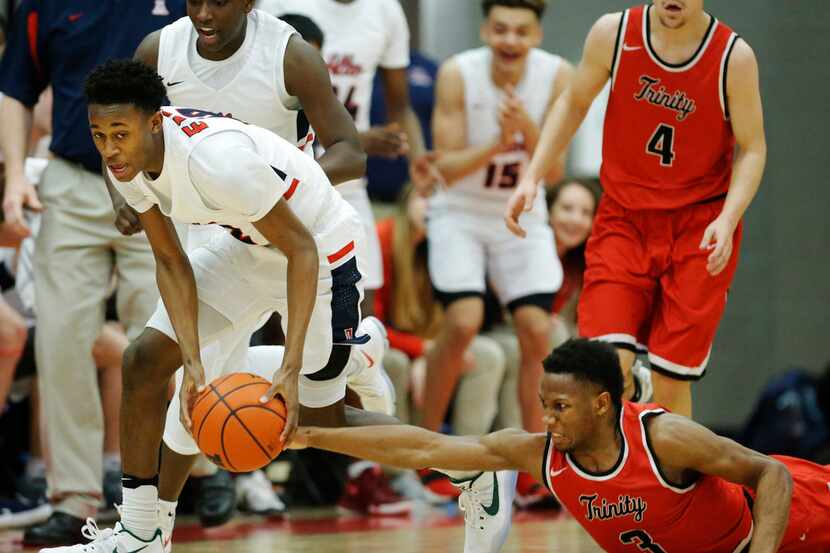 Allen's Korey Jones (12) collects a loose ball as Euless Trinity's Andre Nunley (3) defends...
