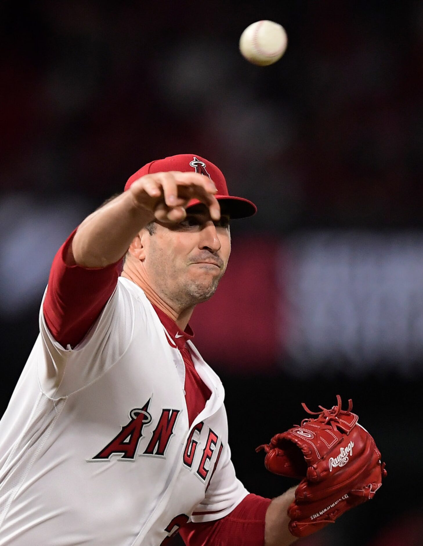 Los Angeles Angels starting pitcher Matt Harvey throws back to first to keep Texas Rangers'...