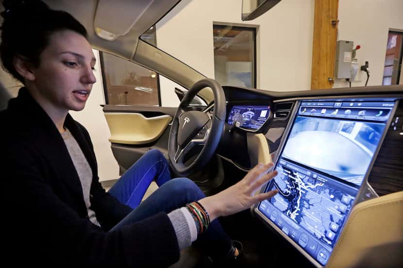 Tesla product specialist Kat Brand explains the control panel on the electric car at a...