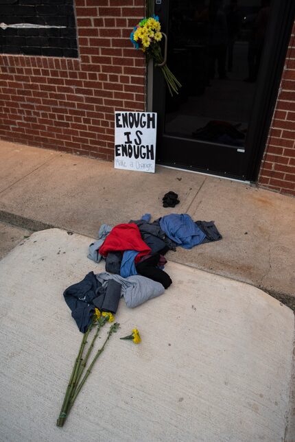 Piles of clothes, coal and flowers were placed outside the entrance to Redfield's Tavern in...