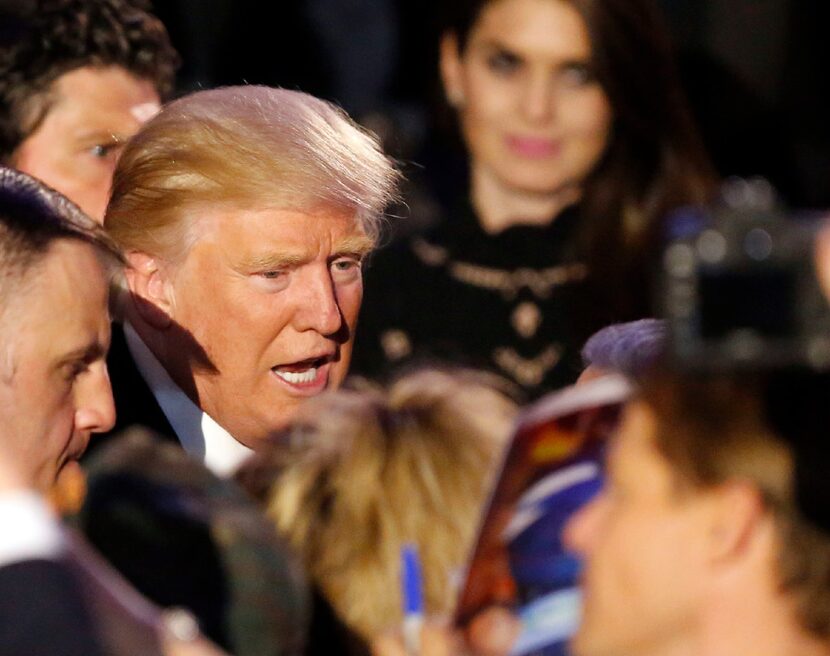 GOP president elect Donald Trump shakes hands with his supporters after making his...