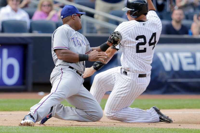 Texas Rangers third baseman Adrian Beltre, left, tags New York Yankees' Gary Sanchez as he...