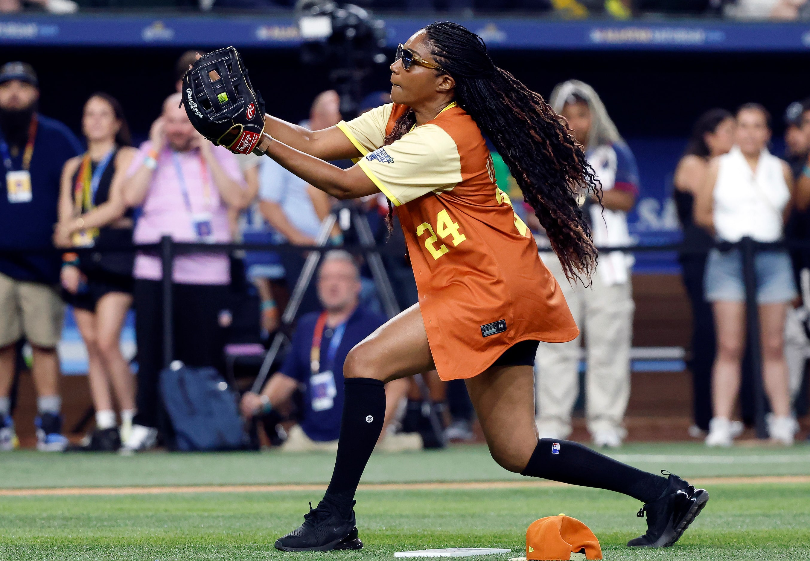 American League pitcher Tiffany Haddish catches a pop-up by National League batter Camille...