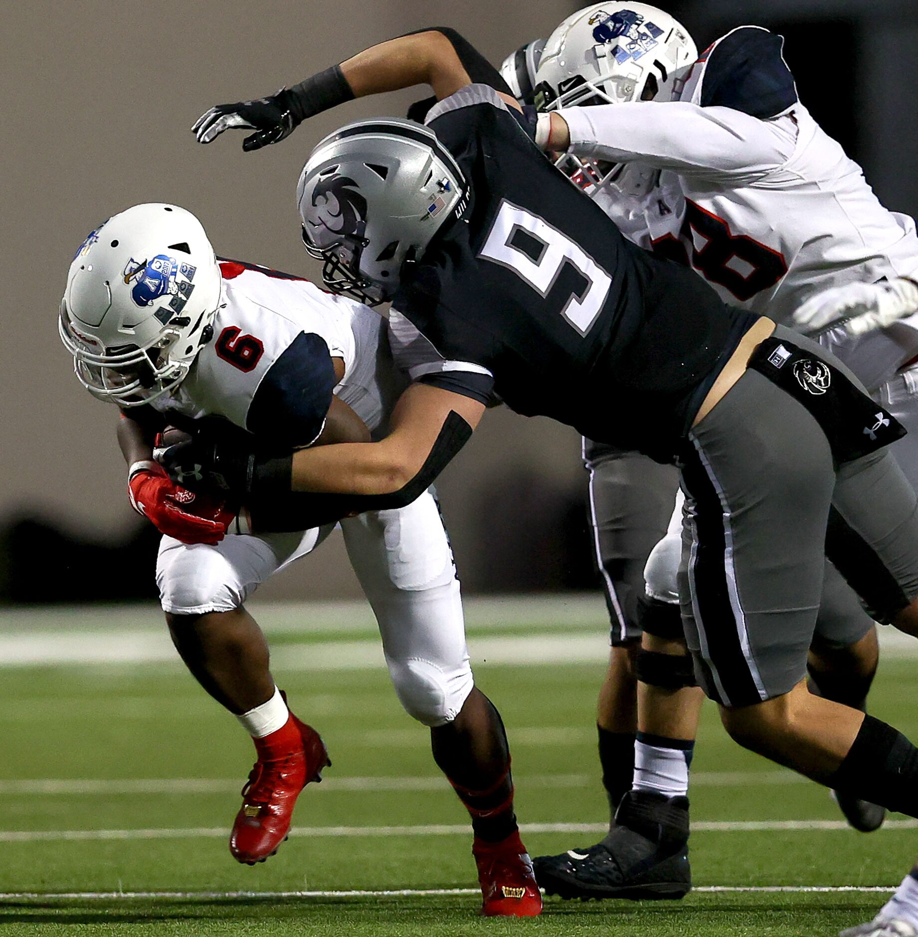 Allen running back Devyn D. Turner (6) tries to break free from Denton Guyer defensive...