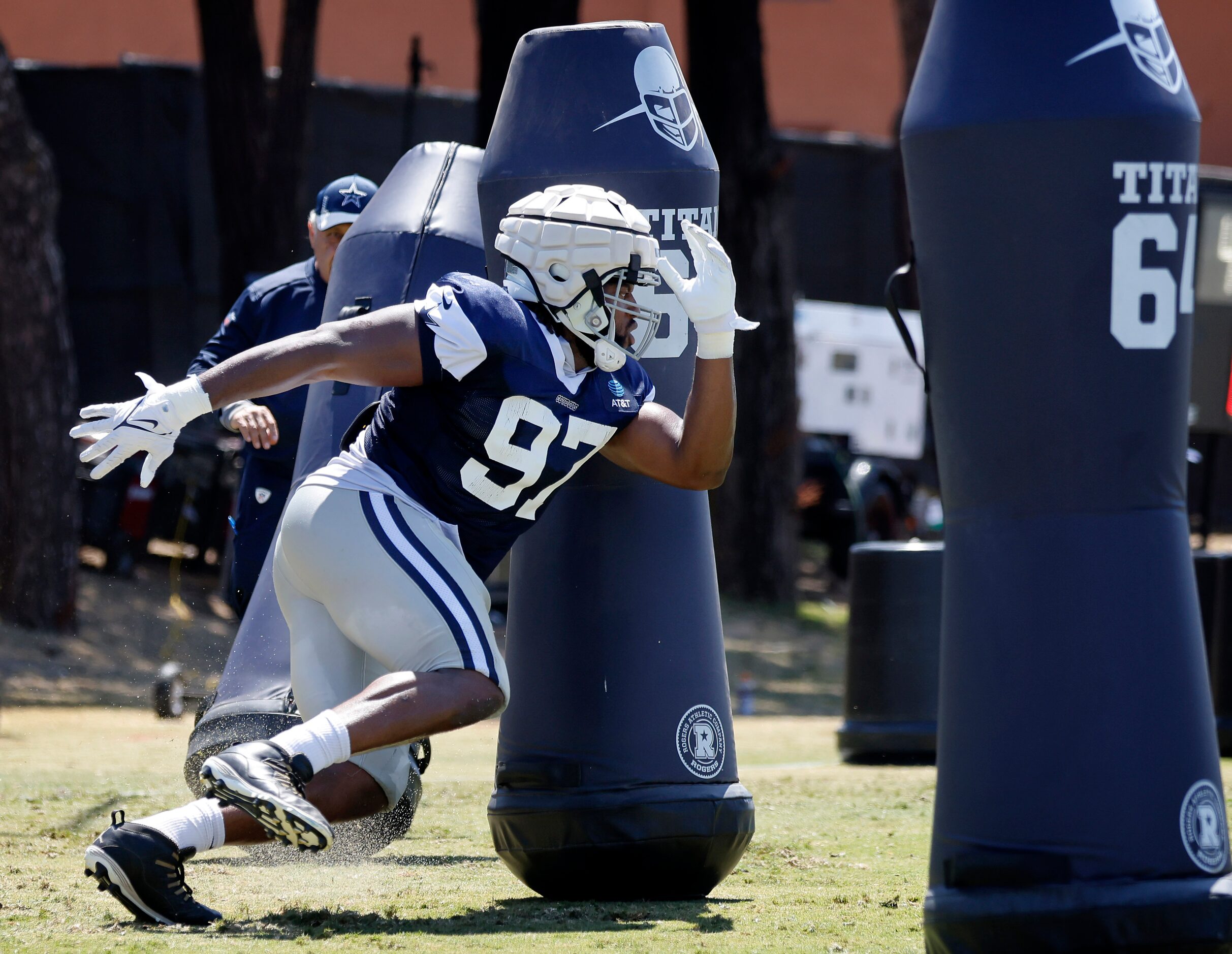 Dallas Cowboys defensive tackle Osa Odighizuwa (97) races around blocking dummies during...