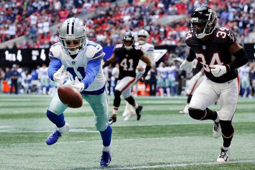 Dallas Cowboys wide receiver Cole Beasley (11) lets the ball slip through his fingers at the...