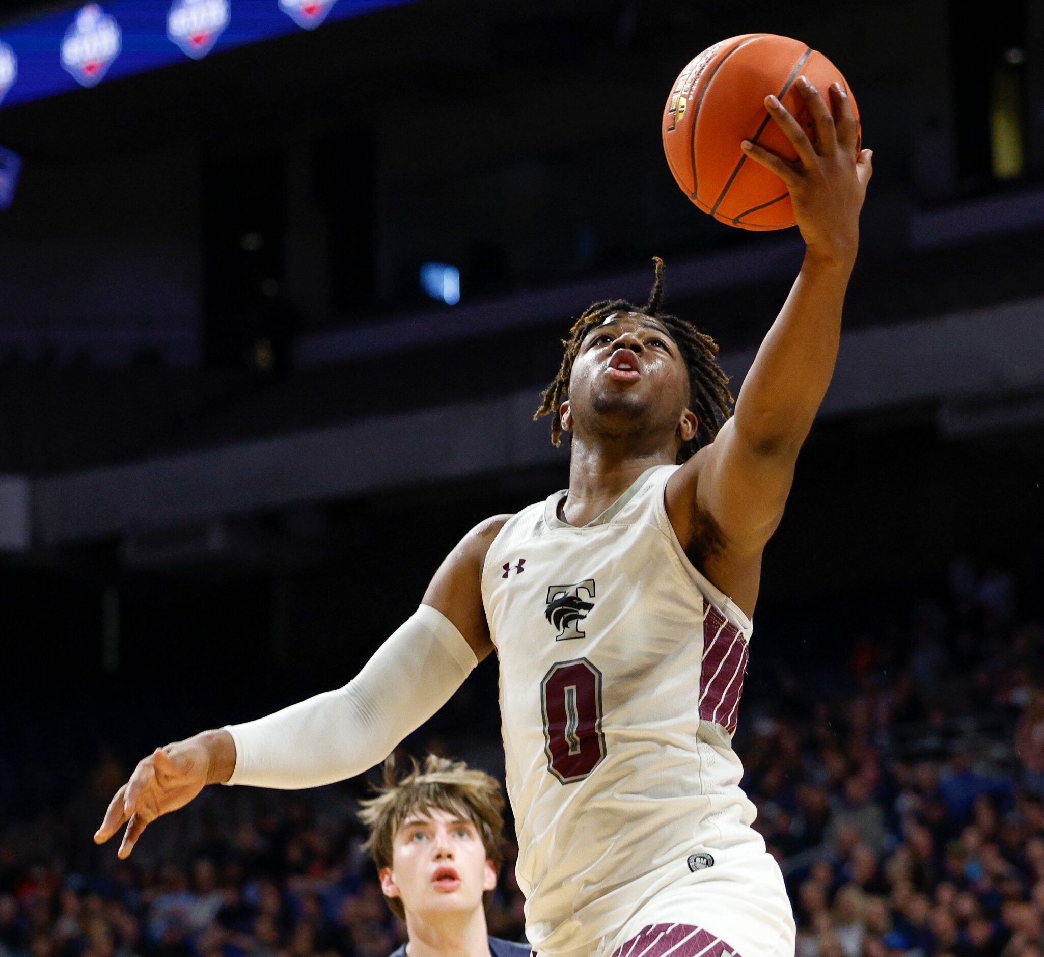 Mansfield Timberview guard Braylon Crosby (0) attempts a layup during the third quarter of a...