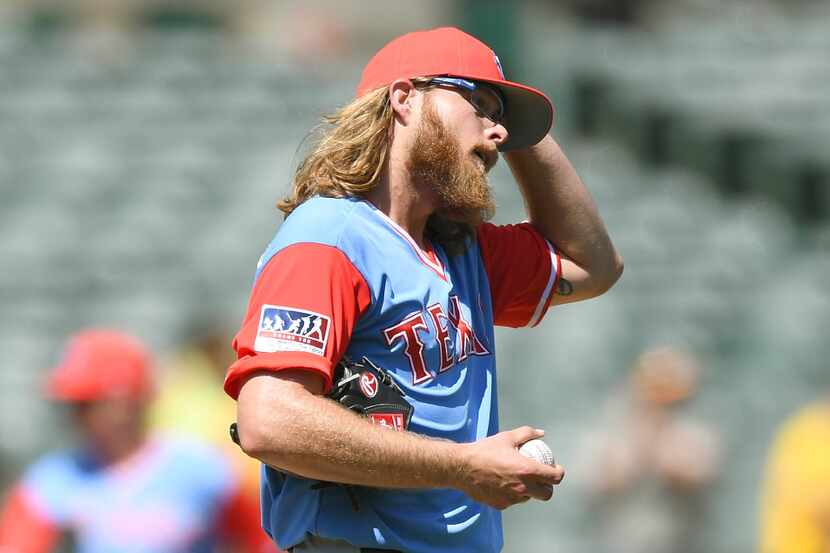 OAKLAND, CA - AUGUST 27:  A.J. Griffin #64 of the Texas Rangers reacts after giving up back...