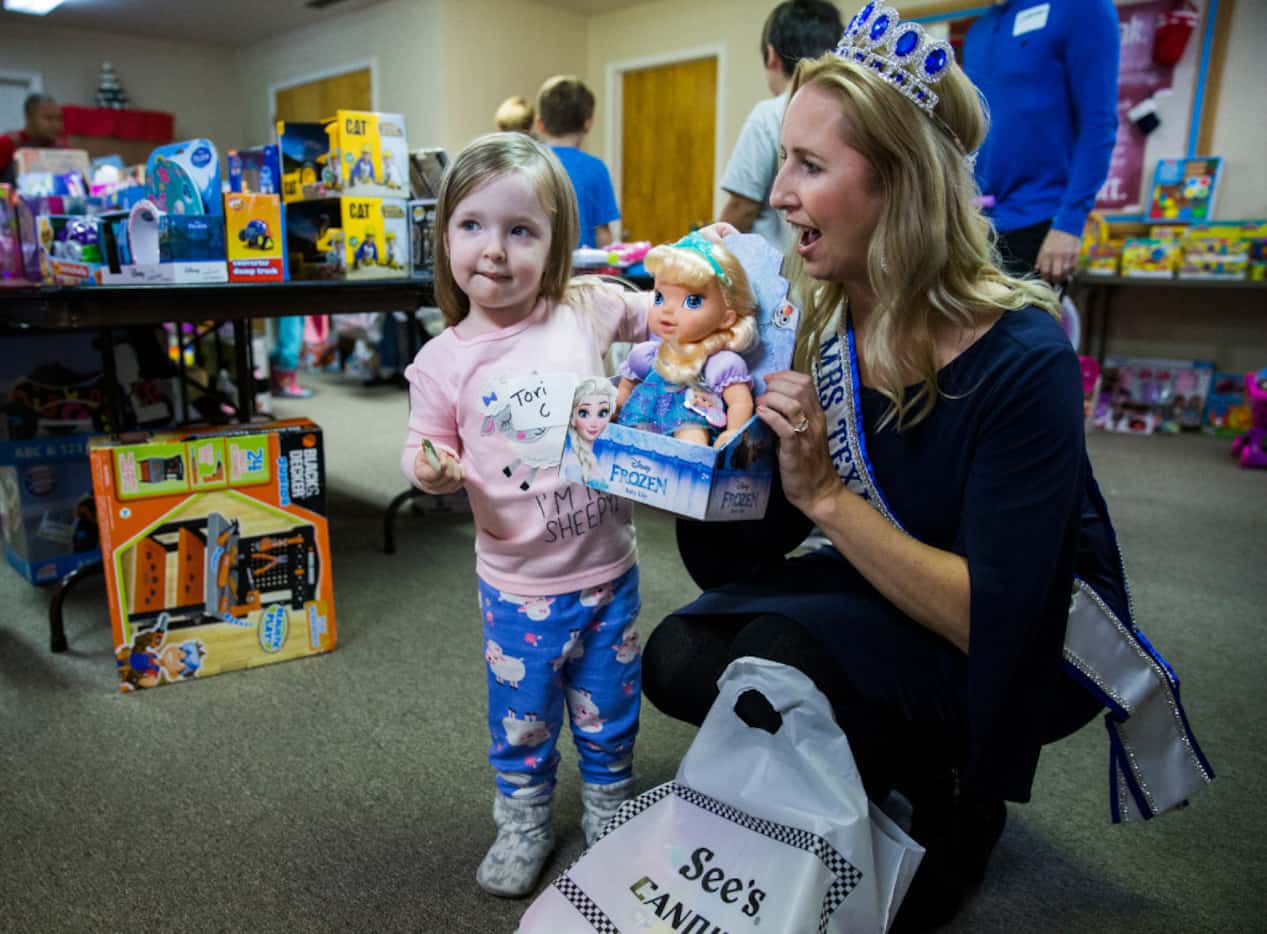 Victoria Carpenter, 3, shows her baby doll to Mrs. Texas Kim Bader during The Big Christmas...