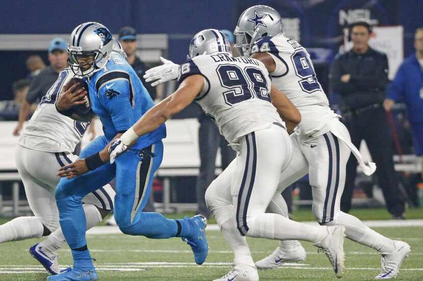 Carolina Panthers quarterback Cam Newton (1) runs for yardage as Dallas Cowboys Tyrone...