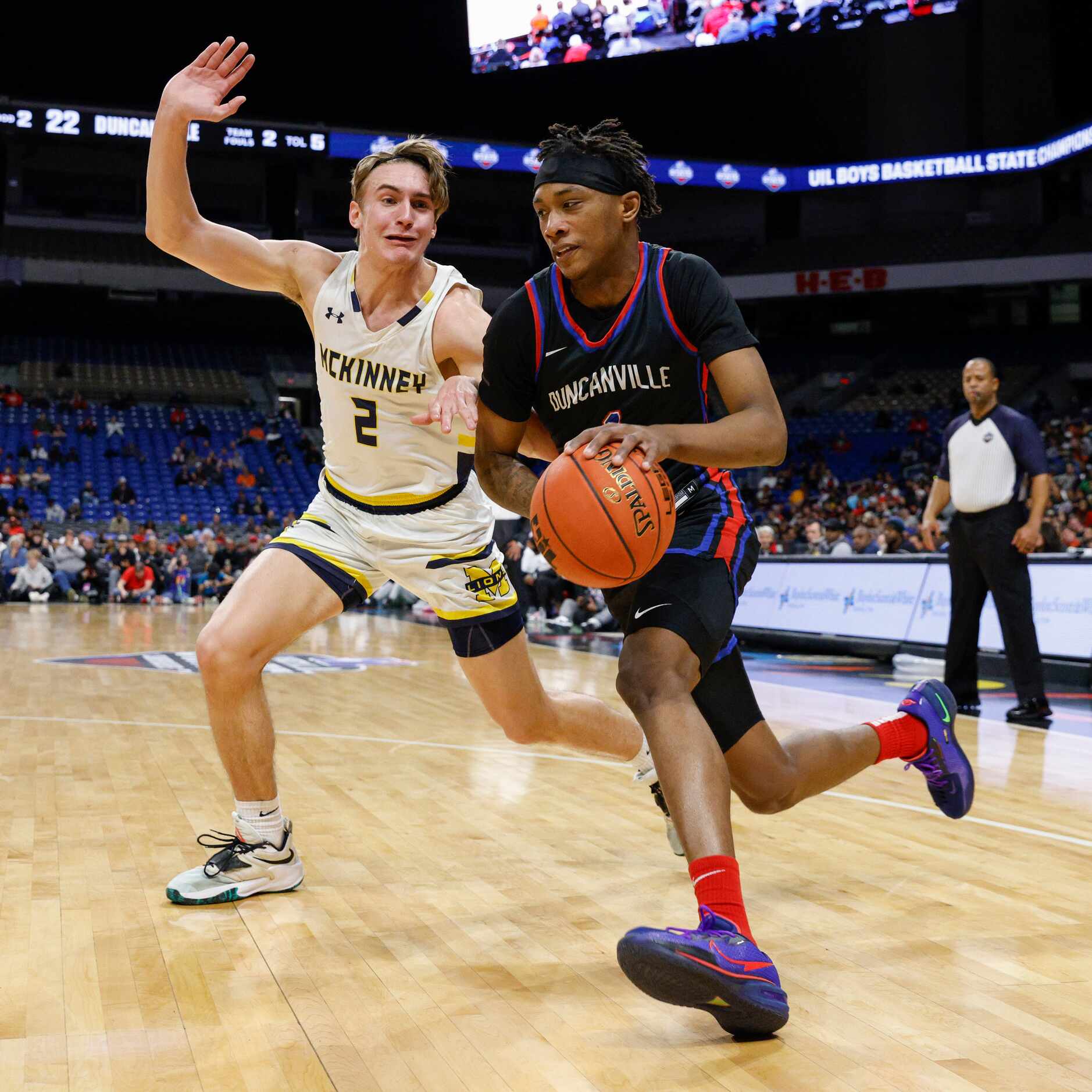 Duncanville forward Ron Holland (1) drives past McKinney guard Jackson Steele (2) during the...