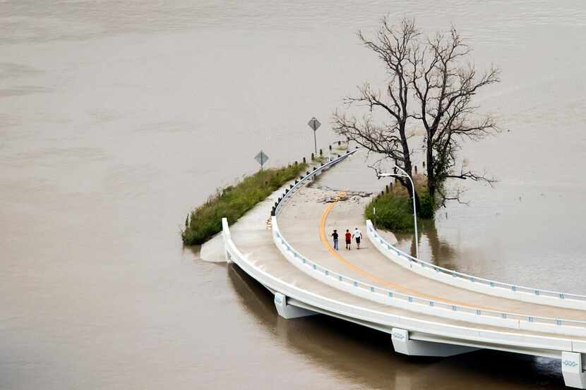 The swollen Trinity River flooded a roadway in the Trinity River Greenbelt Park on May 29,...
