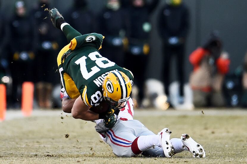 GREEN BAY, WI - JANUARY 8:  Trevin Wade #31 of the New York Giants tackles Jordy Nelson #87...