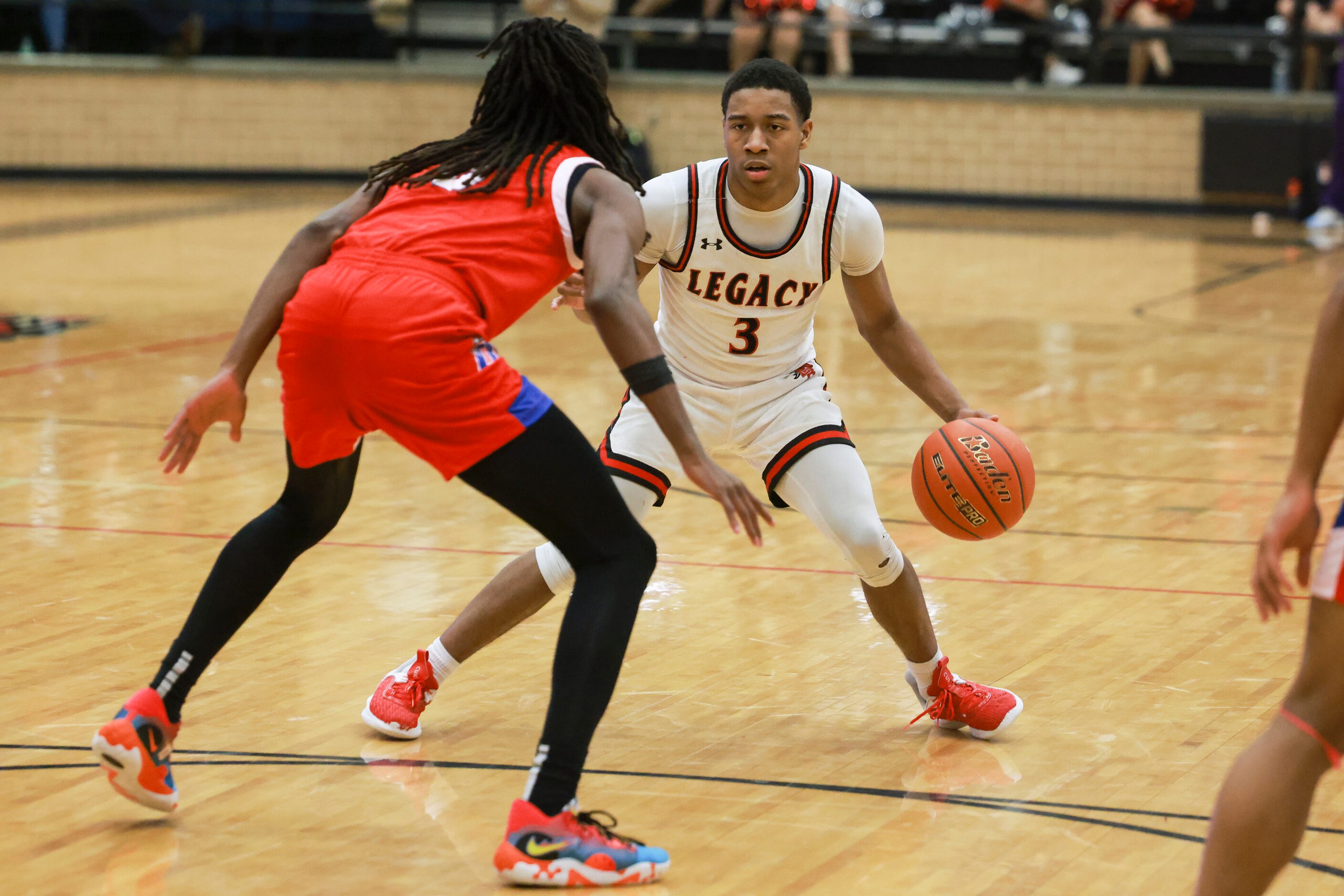 Mansfield Legacy High School’s Jhaden Brown (3) is defended by Duncanville High School’s...