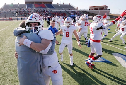 Parish Episcopal's Preston Stone (2) hugs head coach Daniel Novakov in celebration after...