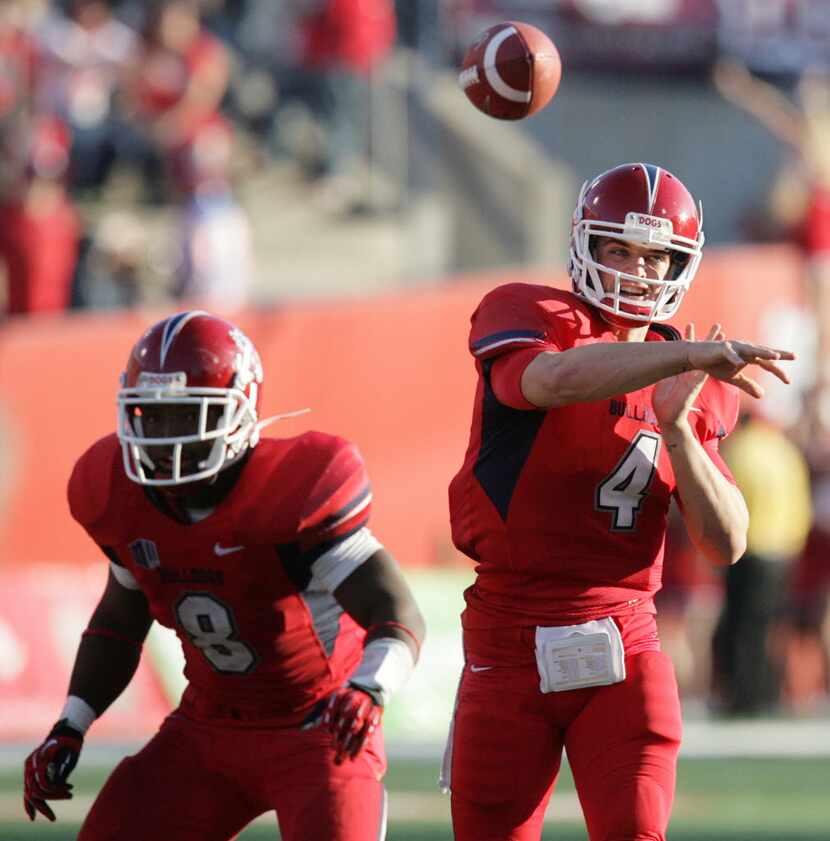 Fresno State quarterback Derek Carr, right, gets protection from Robbie Rouse while throwing...