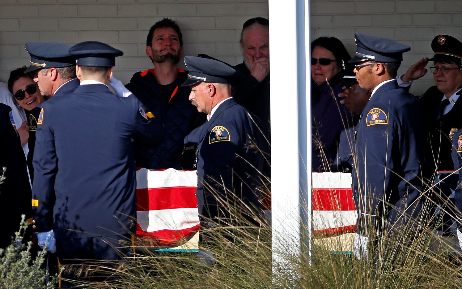 A casket of fallen Dallas firefighter Brian McDaniel is carried into the Sparkman-Crane...