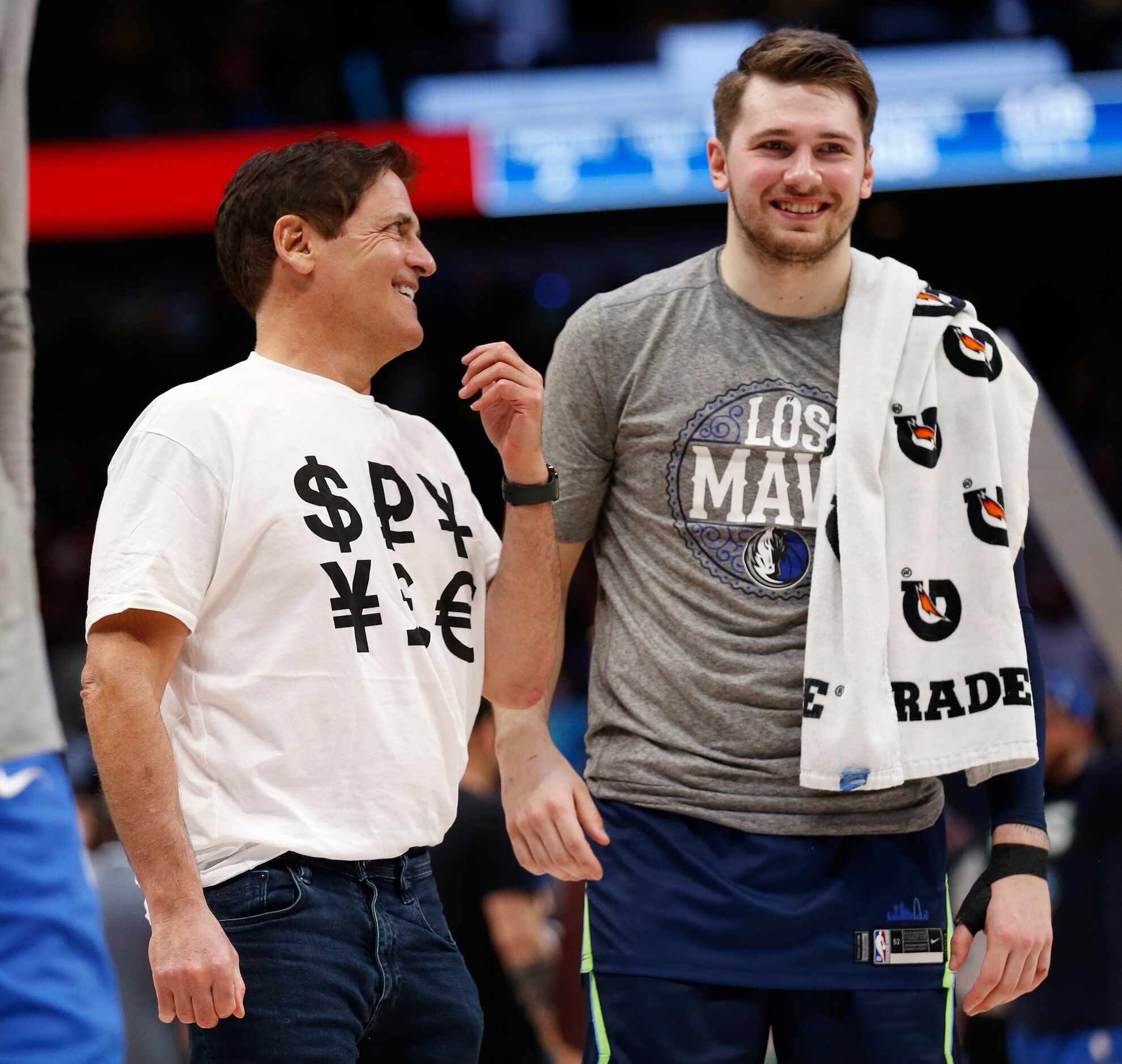 Dallas Mavericks owner Mark Cuban sports a shirt with money signs as he talks to Dallas...
