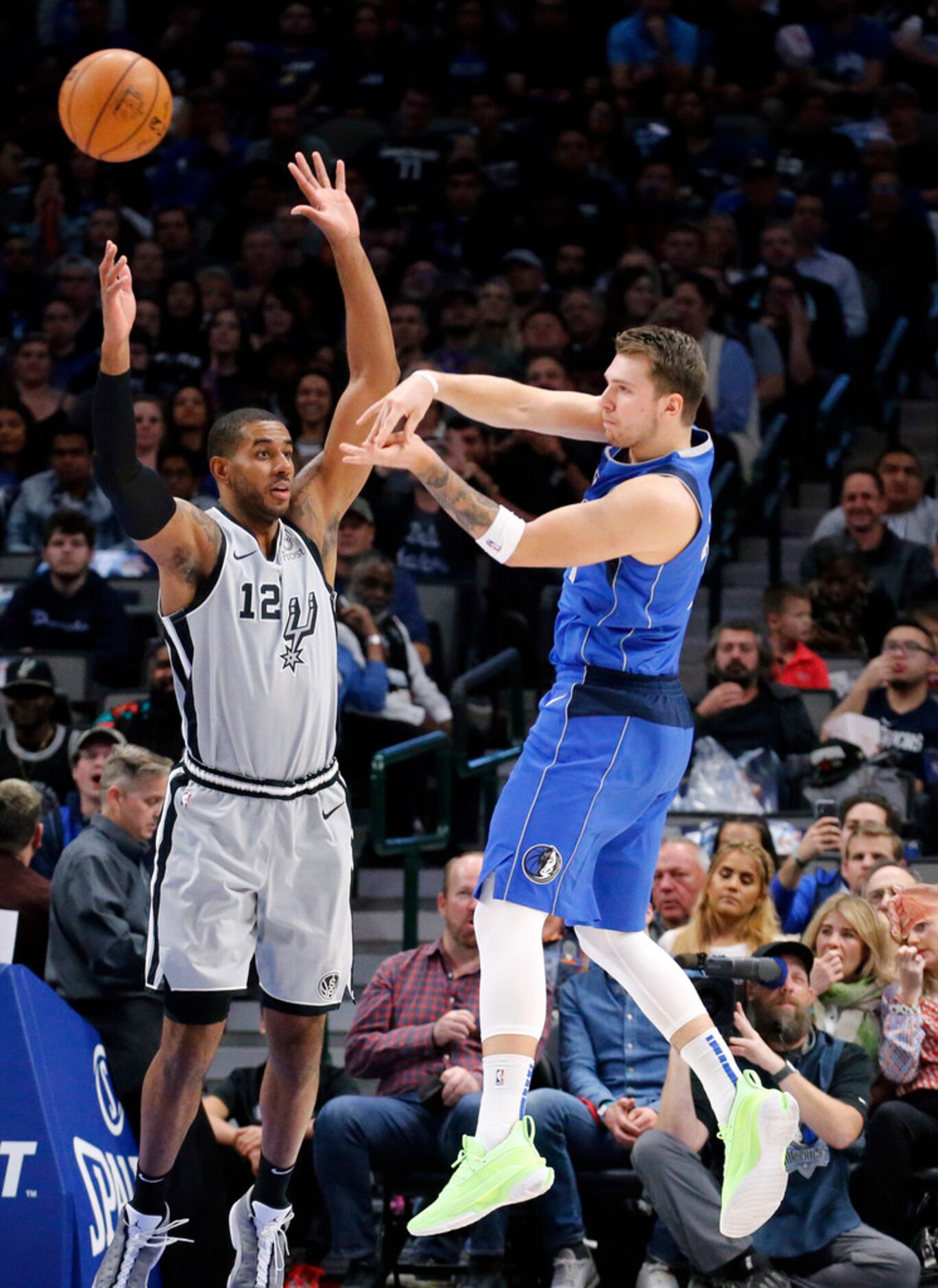 Dallas Mavericks forward Luka Doncic (77) passes the ball against San Antonio Spurs center...