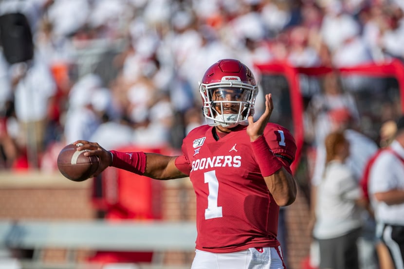 Oklahoma quarterback Jalen Hurts (1) warms up before the start of an NCAA college football...