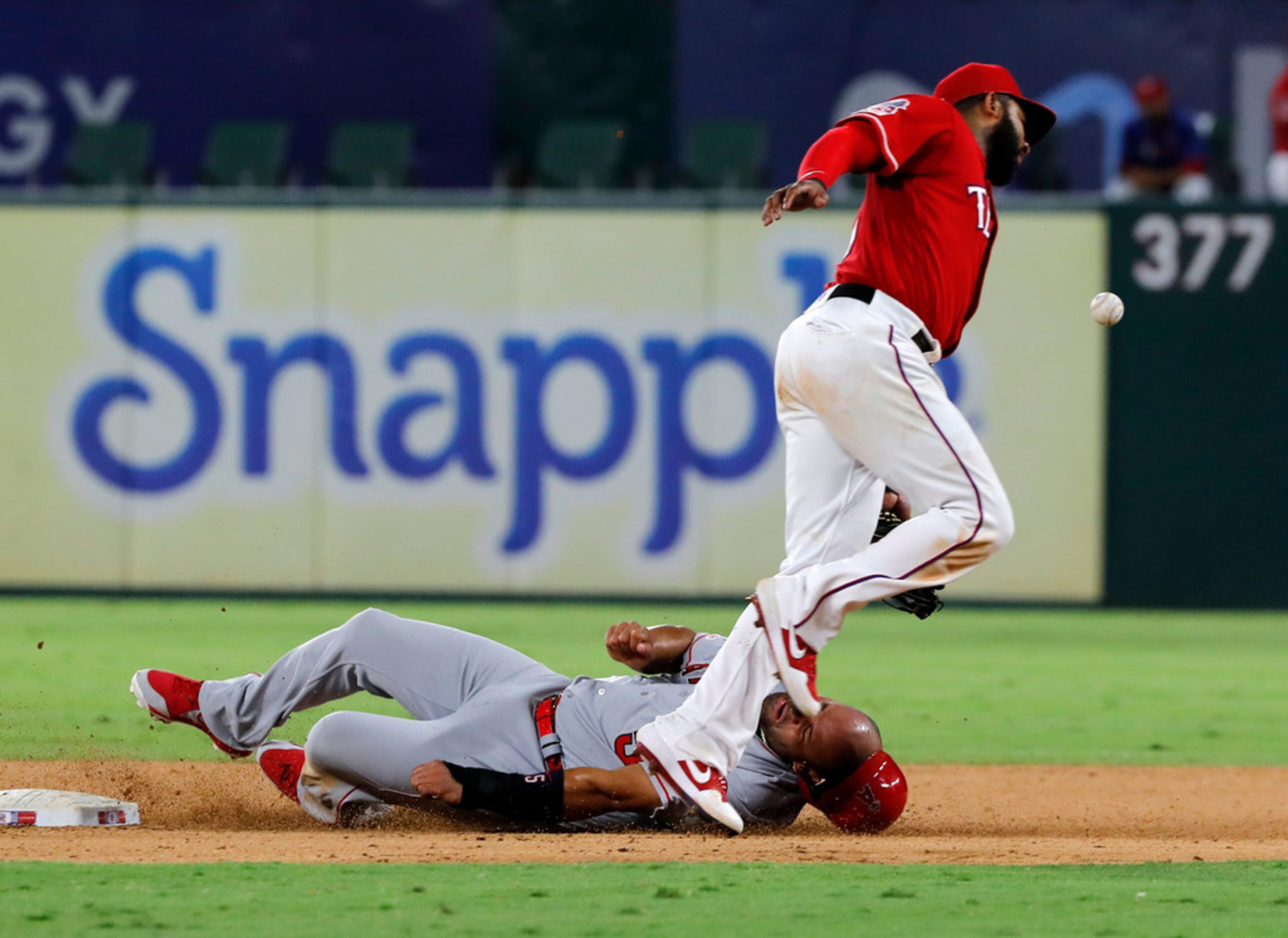 Los Angeles Angels' Albert Pujols steals second as Texas Rangers' Elvis Andrus is unable to...